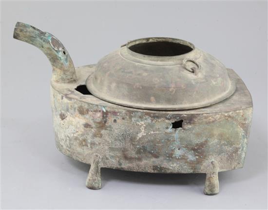 A Chinese archaic bronze steamer vessel, in two parts, Xian, Han dynasty, 206 B.C.-220 A.D., 30cm long, holes